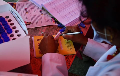 Health worker collecting Swab at out side VIctoria Hospital in Bengaluru on Sunday. (Photo | Shriram BN/EPS)