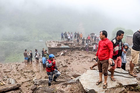 Rescue workers and residents gather for search at the scene of a landslide following heavy rains in Bahrabise municipality of Sindhupalchok district, some 90 kms northeast of Kathmandu. (Photo | AFP)