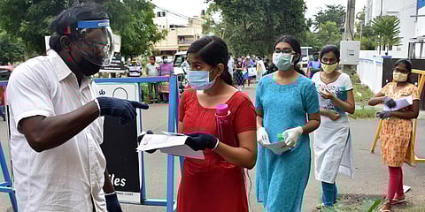 Security personnel checking the documents of a medical aspirant outside a NEET Examination centre in Coimbatore. (Photo| U Rakesh Kumar, EPS)