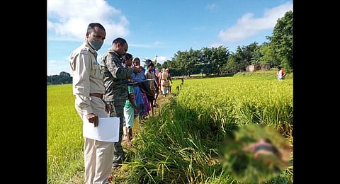 Cops and villagers near the body of Sandeep Tirkey on Monday (Photo | EPS)