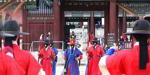 Imperial guards wearing face masks to help protect against the spread of the coronavirus move the Gyeongbok Palace in South Korea. (Photo | AP)