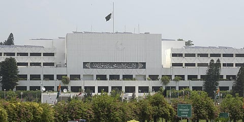 A Pakistani national flag flies at half-mast on the Parliament building in Islamabad. (File photo| AFP)