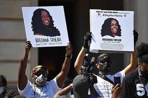 Signs are held up showing Breonna Taylor during a rally in her honor on the steps of the Kentucky State Capitol in Frankfort, Ky., Thursday, June 25, 2020. (Photo | AP)