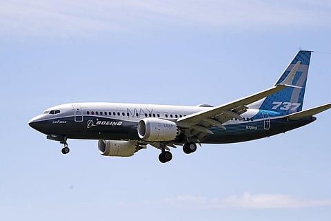 a Boeing 737 Max jet heads to a landing at Boeing Field following a test flight in Seattle. (Photo | AP)
