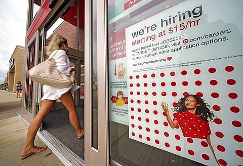A help wanted sign hangs on the door of a Target store in Pennsilvaniya. (Photo | AP)