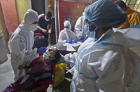Health workers collect a swab sample to test for COVID-19 in Mumbai, India, Wednesday, Sept. 16, 2020. (Photo | PTI)
