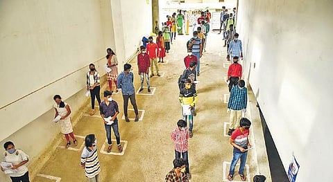Students appearing for TS-EAMCET stand in a queue to enter the examination hall.| Vinay Madapu