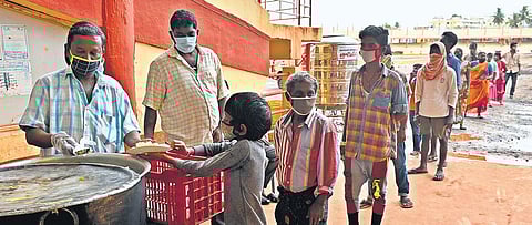 Residents of low-lying areas in Vijayawada being served food after they were shifted to a relief camp set up at IGMC Stadium, on Wednesday | Prasant Madugula