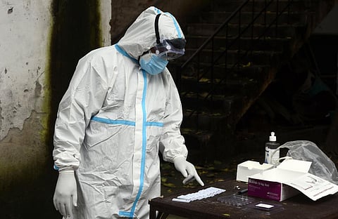 A health worker in PPE coveralls collects COVID-19 samples. (Photo | Parveen Negi, EPS)
