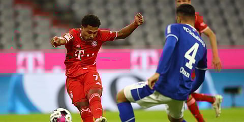 Bayern Munich's Serge Gnabry (L) shoots his opening goal as Schalke's Ozan Kabak (R) tries to stop him, during a Bundesliga match in Munich. (Photo| AP)