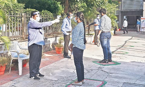 Students’ temperature being checked before appearing for the JEE entrance exam at a centre on Tuesday | Parveen Negi