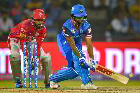 Delhi Capitals' batsman Shikhar Dhawan (R) plays a shot next to Kings XI Punjab's wicketkeeper KL Rahul. (Photo | AFP)