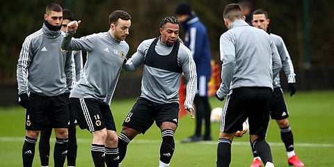 Wolverhampton Wanderers' Adama Traore, centre, and Diogo Jota, centre-left, during the team training session at the Sir Jack Hayward Training Ground in Wolverhampton. (Photo | AP)
