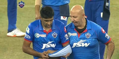 Ravichandran Ashwin's jersey became a temporary sling as he left the field along with Delhi Capitals' physio Patrick Farhard. (Photo | Twitter)