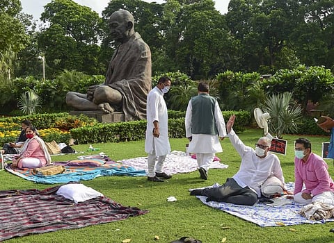 TMC MP Derek O'Brien and Congress MP Rajiv Satav (R), Dola Sen of TMC (L) and others stage a protest over their suspension from the remaining Monsoon Session of Parliament. (Photo | PTI)
