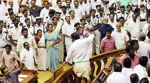 Shining? Not quite! MLA  V Sivankutty seen raising an emergency lamp from the Speaker's dais  in this 2015 budget session file photo. (EPS)