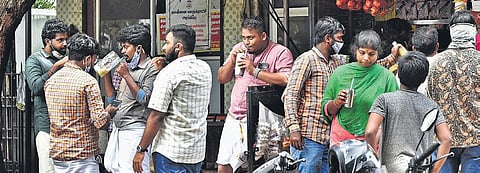 Maintaining no social distancing, people crowd near a juice shop at Saligram on Tuesday | P jawahar