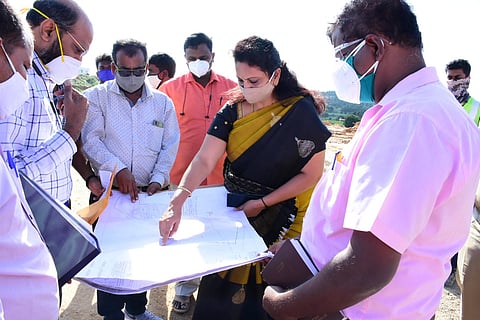 Chikballapur DC R Latha going through the plans for the Medical College at the spot where it is coming up