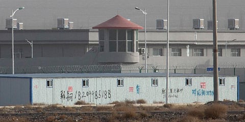 A guard tower and barbed wire fences are seen around a facility in the Kunshan Industrial Park in Artux in western China's Xinjiang region. (File photo| AP)