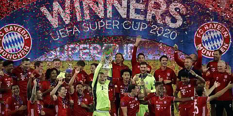 Bayern Munich players celebrate with the trophy after the UEFA Super Cup football match against Sevilla. (Photo | AFP)