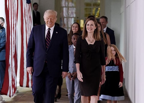 US President Donald Trump (L) and Judge Amy Coney Barrett (R), arrive at the Rose Garden of the White House in Washington, DC. (Photo | AFP)