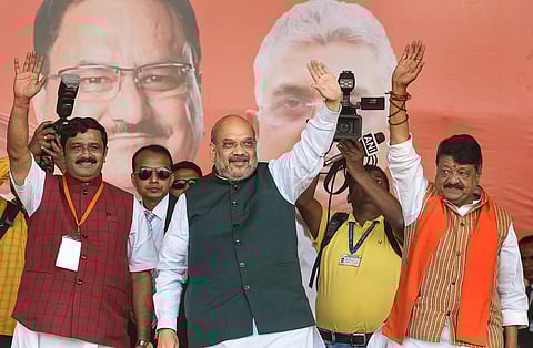 Union Home Minister Amit Shah with BJP national general secretary Kailash Vijayvargiya R and National Secretary Rahul Sinha L during a rally at Shaheed Minar Ground in Kolkata Sunday March 1 2020. (Ph