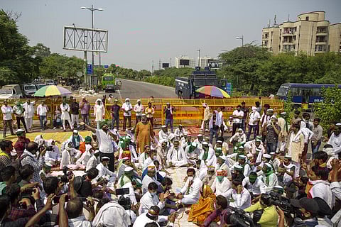 Indian farmers shout slogans as they block a highway during a protest in Noida, India, Friday, Sept. 25, 2020. (Photo | AP)