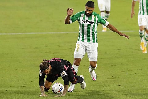 Real Madrid's Sergio Ramos, left, is tackled by Betis' Nabil Fekir during the Spanish La Liga soccer match between Betis and Real Madrid. (Photo | AP)