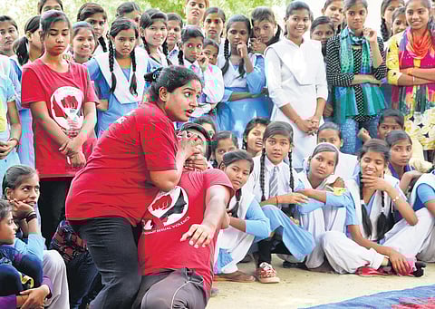 Usha at a camp for school girls; (below) teaching a self-defence technique. (Photo | EPS)