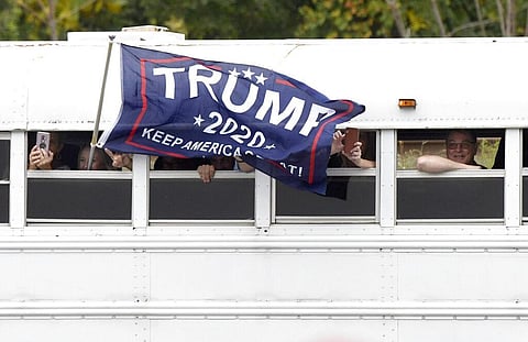 Supporters of President Donald Trump arrive by bus for a Trump campaign rally at Harrisburg International Airport, Saturday. (Photo | AP)