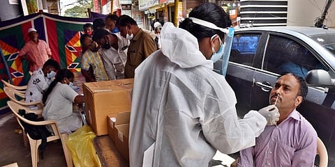 Health staff collecting samples of people during medical camp near Avinashi bridge in Coimbatore. (Photo U Rakesh Kumar, EPS)