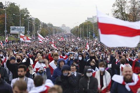 People with old Belarusian national flags march during an opposition rally to protest the official presidential election results in Minsk, Belarus, Sunday, Sept. 27, 2020. (Photo | AP)