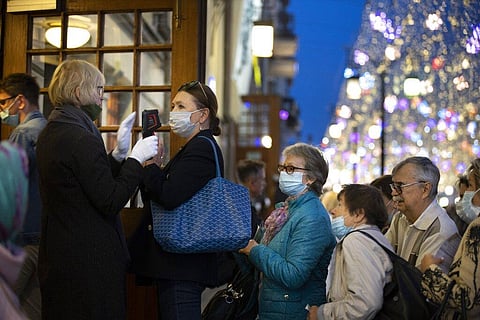 A theater controller measures spectators' temperature at an entrance of Chekhov'v theater in the center of Moscow, Russia. (Photo | AP)