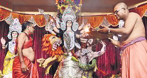 Despite the gloom, Bengalis in the city are leaving no stone unturned to welcome their Ma.