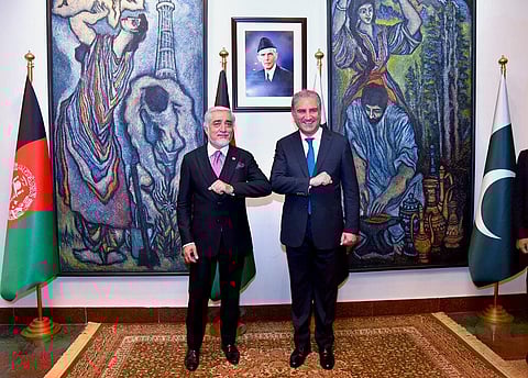 Abdullah Abdullah, left, chairman of Afghanistan's High Council for National Reconciliation, bumps elbows with Pakistani Foreign Minister Shah Mahmood Qureshi. in Islamabad. (Photo | AP)