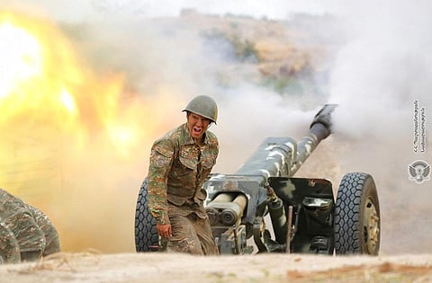 In this photo released by Ministry of Defense of Armenia on Tuesday, an Armenian soldier fires an artillery piece during fighting with Azerbaijan's forces. (Photo | AP)