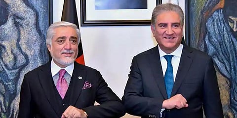 Abdullah Abdullah (L) chairman of Afghanistan's High Council for National Reconciliation, bumps elbows with Pakistani Foreign Minister Shah Mahmood Qureshi, during a meeting in Islamabad. (Photo | AP)