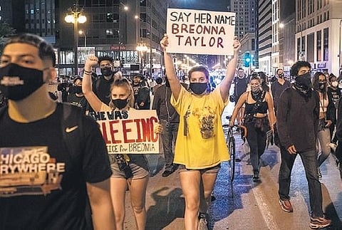 Protesters march  in Chicago against the decision of a Kentucky grand jury not to slap manslaughter charges on police officers involved in the fatal shooting of Breonna Taylor (Photo | AP)