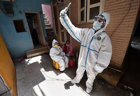 A medic collects blood samples for serological survey to analyse the spread of COVID-19 at Paharganj in New Delhi  (File Photo | PTI)