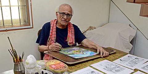Artist Sankar and his artwork. (Photo | EPS/Martin Louis)