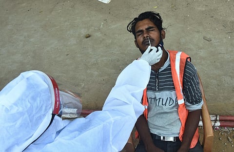 Chennai corporation collecting swabs from migrant workers at a construction site. (Photo | Ashwin Prasath, EPS)
