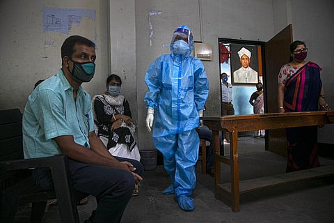 An Indian health worker prepares to take nasal swab samples of teachers to test for COVID-19 at a school before classes open in Gauhati, India, Wednesday, Sept. 2, 2020.  (Photo | AP)
