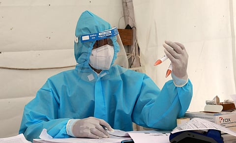 A health worker notes down reading from the samples collected for serological test. (Photo | Shekhar Yadav, EPS)
