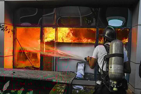 A firefighter attempts to douse a blaze at Raymond Company in Thane Wednesday morning Sept. 30 2020. (Photo | PTI)