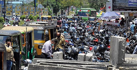 Two-wheelers and autorickshaws parked on the roadside at Menaka Junction in the city. (Photo | A Sanesh, EPS)