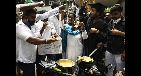 Youth Congress members prepare ‘bajji’ during a demonstration. (Photo | Vinod Kumar T, EPS)