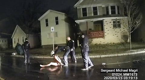 A Rochester cop puts a hood over the head of Daniel Prude, on March 23, 2020, a Black man who had run naked through the streets of New York. (Photo | AP)