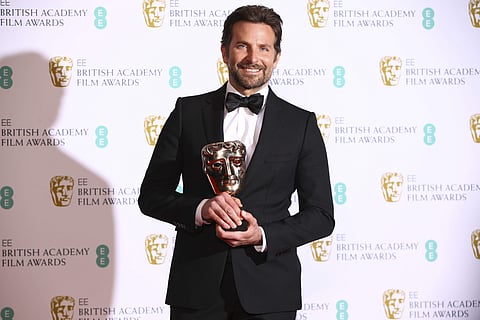 Bradley Cooper poses for photographers backstage with the Best Original Music award for the film 'A Star is Born' at the BAFTA awards in London. (AP photo)