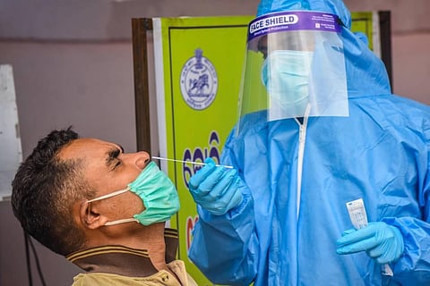 A health worker collects swab sample for rapid antigen test at Unit-3 Urban Primary Health Center UPHC in Bhubaneswar (Photo | Biswanath Swain, EPS)