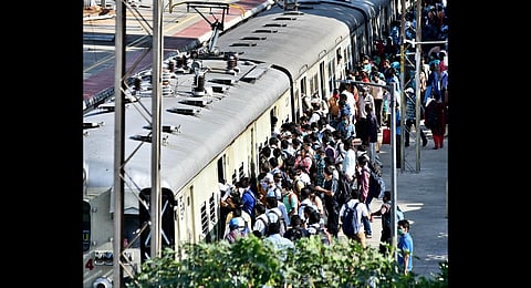 People crowding the Basin Bridge railway station to board a train being operated for government employees. (Photo | P Jawahar, EPS)